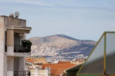 a view of a city with a mountain in the background at Penthouse Anneliese in Athens