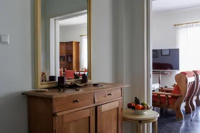 a bathroom with a wooden dresser with a large mirror at Penthouse Anneliese in Athens