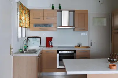 a kitchen with a sink and a stove top oven at Penthouse Anneliese in Athens
