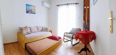 a living room with a couch and a chair at Penthouse Anneliese in Athens