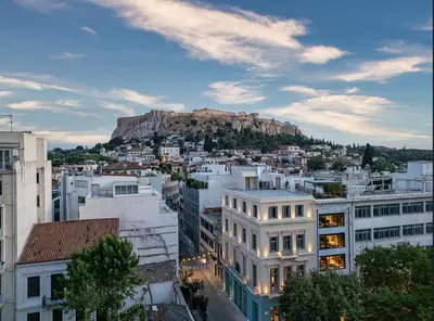 a view of a city with a mountain in the background at Nine Athens Hotel in Athens