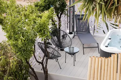 a patio with chairs and a sink and trees at Athenian Secret Glyfada in Athens