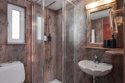 a bathroom with a toilet and a sink and a shower at Athenian Secret Glyfada in Athens