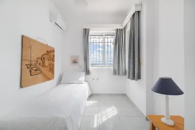 a bedroom with two beds and a lamp and a window at Villa Asossa with Private pool & Sea view in Dhaskalión