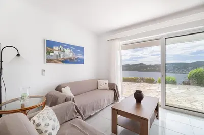 a living room with a couch and a large window at Villa Asossa with Private pool & Sea view in Dhaskalión