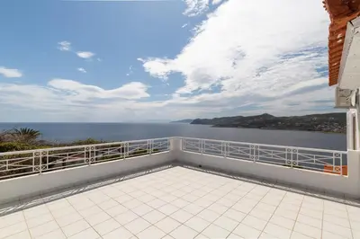 a balcony with a view of the water at Villa Asossa with Private pool & Sea view in Dhaskalión