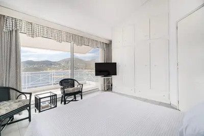 a bedroom with a bed and a large window at Villa Asossa with Private pool & Sea view in Dhaskalión