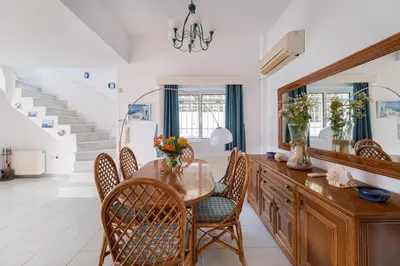 a dining room with a table and chairs at Villa Asossa with Private pool & Sea view in Dhaskalión