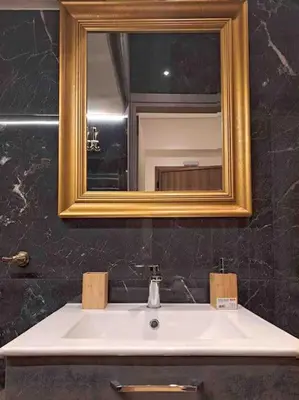 a bathroom with a sink and a mirror at ROYAL BLUE GRAND Suite No 4 Piraeus Port in Piraeus