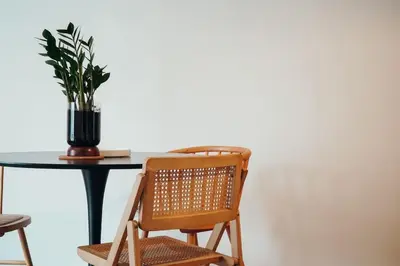 a chair and a table with a potted plant at Charming Apartment in Keramikos in Athens