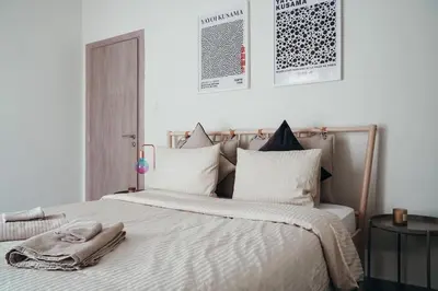 a bedroom with a large bed with a towel on it at Charming Apartment in Keramikos in Athens