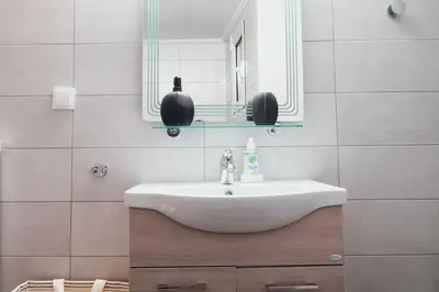 a bathroom with a white sink and a mirror at Charming Apartment in Keramikos in Athens