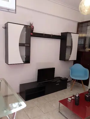 a living room with a mirror and a laptop on a wall at Kipseli house in Athens