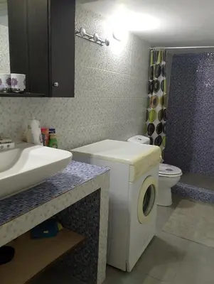 a bathroom with a washing machine and a sink at Kipseli house in Athens