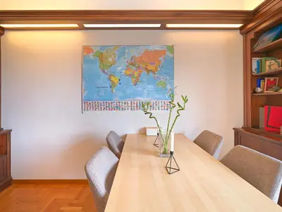 a conference room with a table and a map on the wall at Central Pagrati Apartment with Park View Balcony - opp Pangrati Grove in Athens