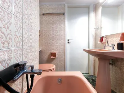 a bathroom with a pink tub and a sink at Central Pagrati Apartment with Park View Balcony - opp Pangrati Grove in Athens