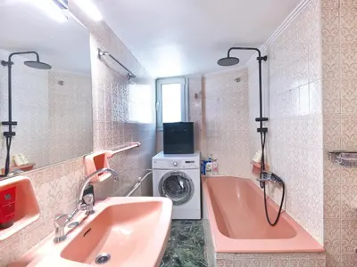 a bathroom with a pink tub and a washing machine at Central Pagrati Apartment with Park View Balcony - opp Pangrati Grove in Athens