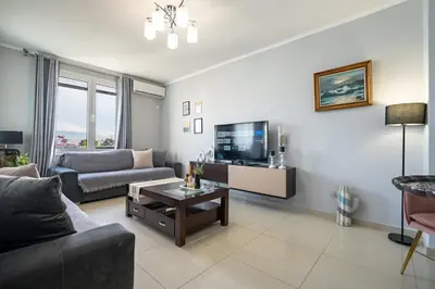 a living room with a couch and a tv at Μercy suit in Piraeus
