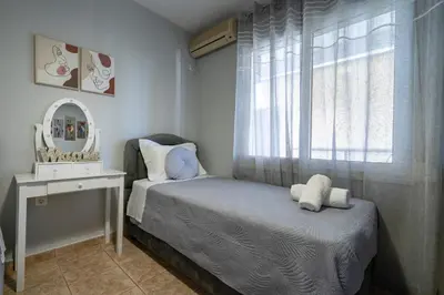 a small bedroom with a bed and a mirror at Μercy suit in Piraeus