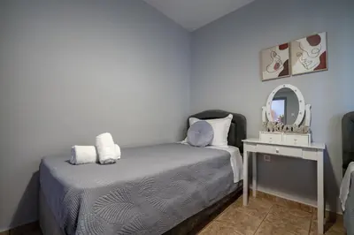 a small bedroom with a bed and a mirror at Μercy suit in Piraeus