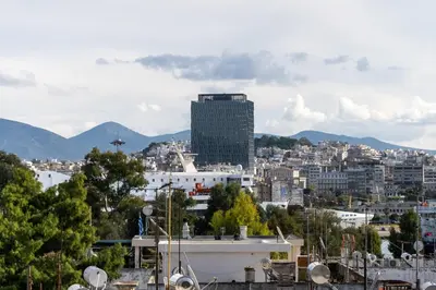 a view of a city with mountains in the background at Μercy suit in Piraeus