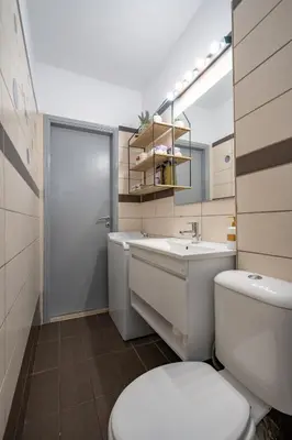 a bathroom with a white toilet and a sink at Μercy suit in Piraeus