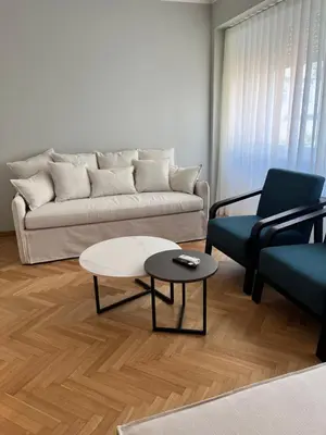 a living room with a couch and a table and chairs at Central44 Luxury Apartment Ermou in Athens