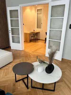 a living room with a white table and a table at Central44 Luxury Apartment Ermou in Athens