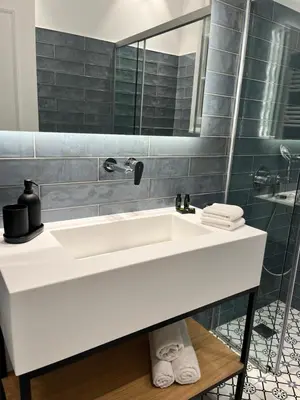a bathroom with a white sink and a mirror at Central44 Luxury Apartment Ermou in Athens