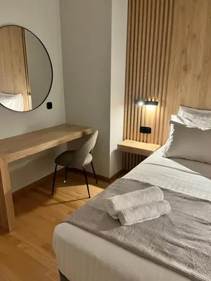 a bedroom with a bed with a desk and a mirror at Central44 Luxury Apartment Ermou in Athens