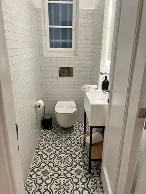 a white bathroom with a toilet and a sink at Central44 Luxury Apartment Ermou in Athens