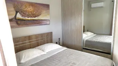 a bedroom with two beds and a painting on the wall at Veta's Luxury apartment near the beach. in Lagonissi