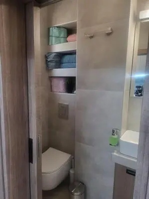 a small bathroom with a toilet and a sink at Bovis Apartments #2 in Porto Rafti
