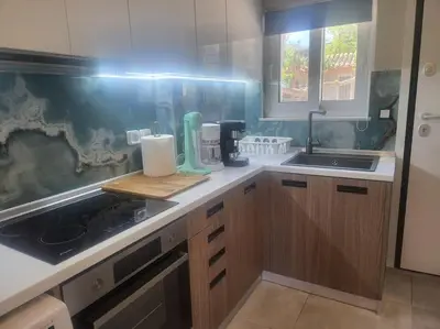 a kitchen with a sink and a counter top at Bovis Apartments #2 in Porto Rafti