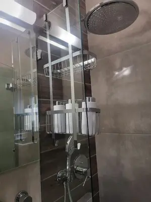 a bathroom with a shower with a glass door at Bovis Apartments #2 in Porto Rafti