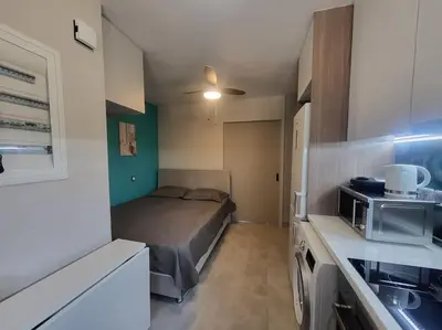 a small kitchen with a bed in a small room at Bovis Apartments #2 in Porto Rafti