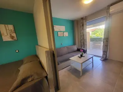 a living room with a couch and a table at Bovis Apartments #2 in Porto Rafti