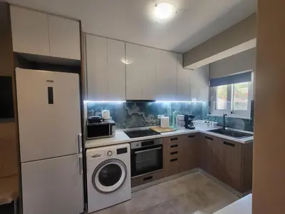 a kitchen with a refrigerator and a washer at Bovis Apartments #2 in Porto Rafti