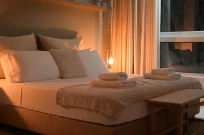 a bedroom with a bed with towels on it at Athens Host - Harmony in Athens