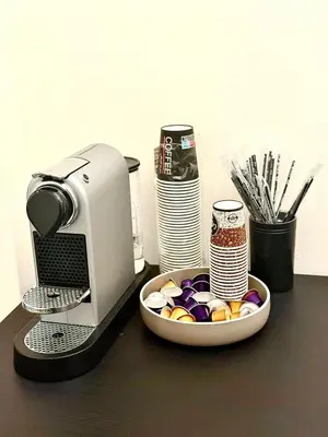 a coffee maker and a bowl of candy on a table at Athens Host - Harmony in Athens