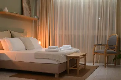 a bedroom with a bed and a chair and a window at Athens Host - Harmony in Athens