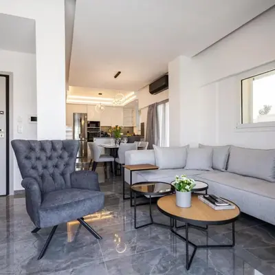 a living room with a couch and chairs and tables at Parthenon view luxury penthouse in Athens