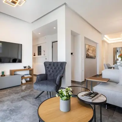 a living room with a couch and a table at Parthenon view luxury penthouse in Athens