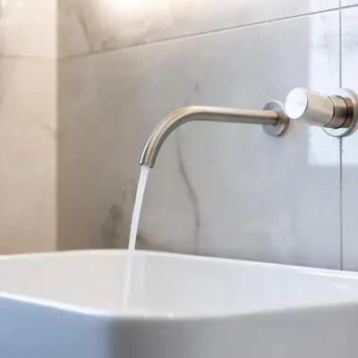a sink with water pouring from a faucet in a bathroom at Parthenon view luxury penthouse in Athens