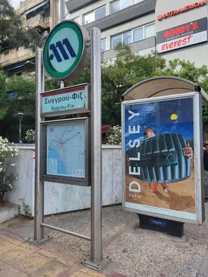 a bus stop with a sign next to a bus at Parthenon view luxury penthouse in Athens