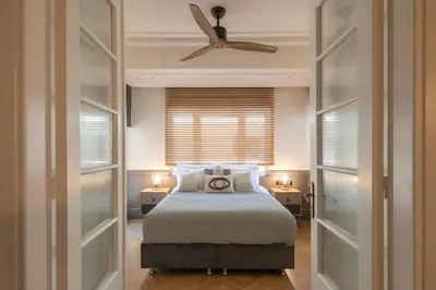 a bedroom with a bed and a ceiling fan at DIOS Zeus Temple View 1 Bedroom Apartment in Athens