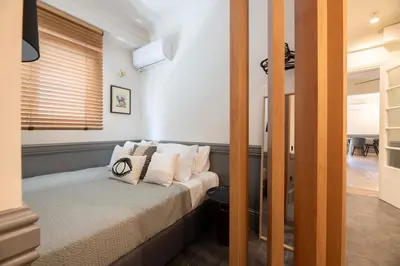 a bedroom with a bed with white pillows at DIOS Zeus Temple View 1 Bedroom Apartment in Athens