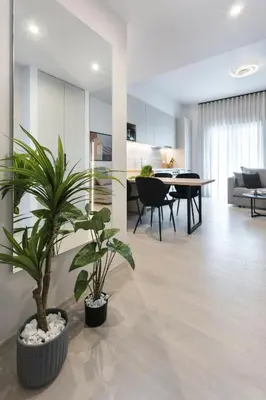 a living room with two potted plants on the floor at Athenian Modern & Luxury Apartments in Athens