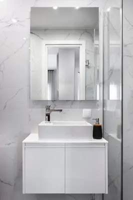 a white bathroom with a sink and a mirror at Athenian Modern & Luxury Apartments in Athens