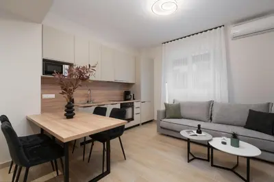 a living room with a table and a couch at Athenian Modern & Luxury Apartments in Athens
